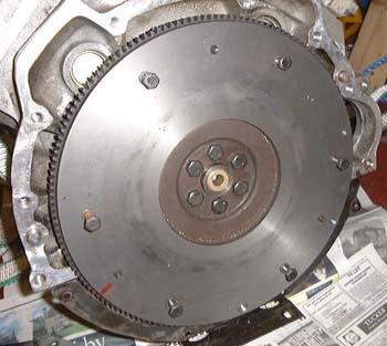 Flywheel, and offending plate